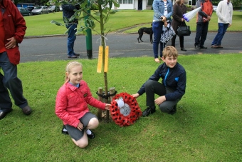 Pupils lay wreath at tree